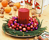 Wreath with red and purple baubles and red candle