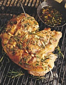 Shoulder of lamb with rosemary on barbecue