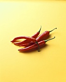 Four red chili peppers