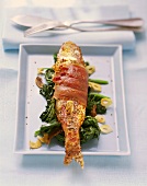 Bacon-wrapped red mullet on spinach