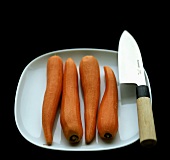 Peeled carrots with knife