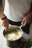 Stirring mashed potato in pan