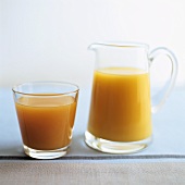 Orange juice in glass and carafe