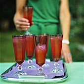 Drinks with strawberries on tray in open air