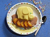 Blancmange elephant with clementines and chocolate sauce