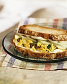 Egg salad and cucumber slices in a sandwich