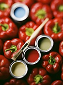 Red peppers and paint pots with paintbrush