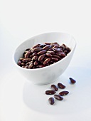 Kidney beans in and in front of a bowl