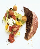 Lamb steak with vegetable and feta salad