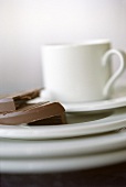 Coffee cup with saucer and chocolate