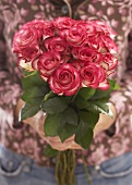 Hands holding bouquet of roses