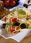 Spaghetti with olives, tomatoes, basil and Parmesan