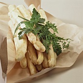 White asparagus with herbs on paper