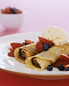Crepes with chocolate filling, berries & vanilla ice cream