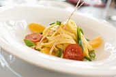 Ribbon pasta with tomatoes, spring onions and orange