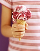 Amarena cherry ice cream cone in child's hand