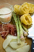 Ingredients for ribbon pasta with asparagus and bacon
