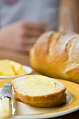 Bread and butter with knife and loaf of bread
