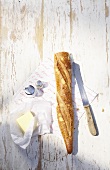 Baguette with butter, salt and pepper shakers