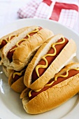 Six hot dogs with mustard
