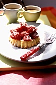 Small strawberry flan with icing sugar