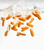 Baby carrots falling into water
