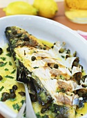 Fried sea bass with lemon and capers