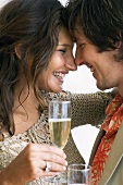 Young lovers holding glasses of sparkling wine