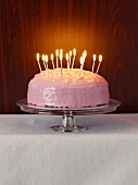 A birthday cake with burning candles