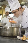 Chef smelling a cooked carrot