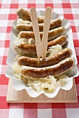 Sausages and sauerkraut in paper dish