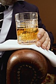 Man holding a glass of whisky