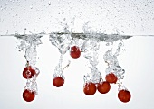Cherries falling into water