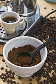 Cup of espresso, espresso machine, ground coffee, coffee beans