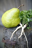 Green pear and Hamburg parsley on wood