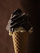 Soft ice cream with chocolate sauce in cone