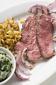 Slices of steak with diced potatoes, onions and spinach