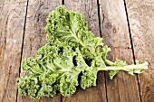 Two kale leaves on wooden background