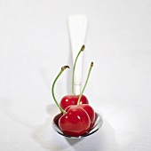 Three cherries on spoon