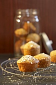Muesli muffins on cake rack and in storage jar