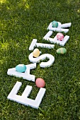 Easter eggs and the word EASTER on grass