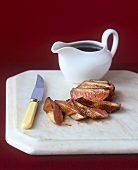 Sliced duck with gravy boat