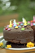 Chocolate cake with coloured chocolate beans and candles