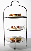 Savouries and cakes for afternoon tea on tiered stand