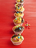 Muffins decorated with coloured chocolate beans
