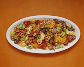 Various types of tomatoes, sliced, on plate