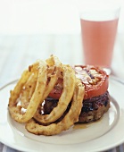 Turkey burger with slice of tomato & deep-fried onion rings