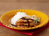Fish cakes with soy sauce, rice and cucumber relish