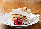 A piece of meringue cake with berries