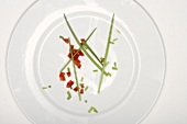 Chives and diced red pepper on plate